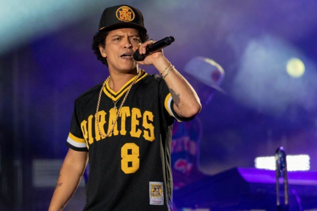 bruno mars I svart keps sjunger i mikrofon