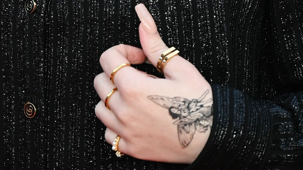 Här ser vi tatueringens motiv, två änglabarn. billie eilish tatuering på handen
