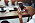 Bild på en tjej som håller i sin mobiltelefon på ett cafe.